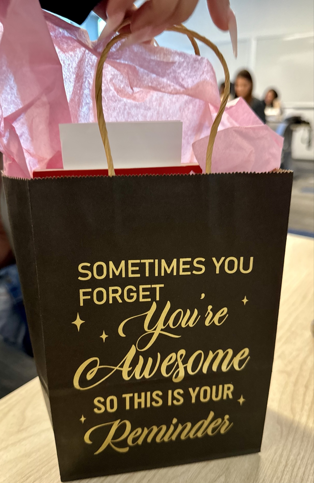Black gift bag with the message 'Sometimes you forget you're awesome so this is your reminder', given to 2025 cohort participants.
