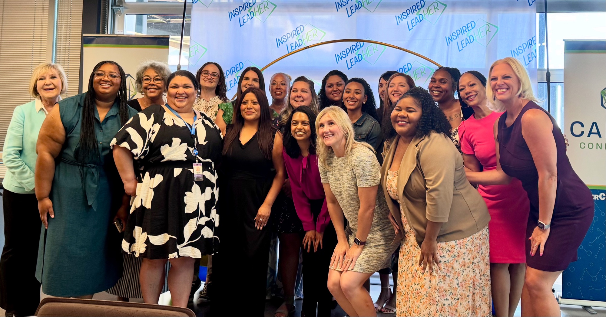 The 2025 inaugural Inspired LeadHER cohort: 16 women smiling together at the Achieve campus in Tempe, Arizona.