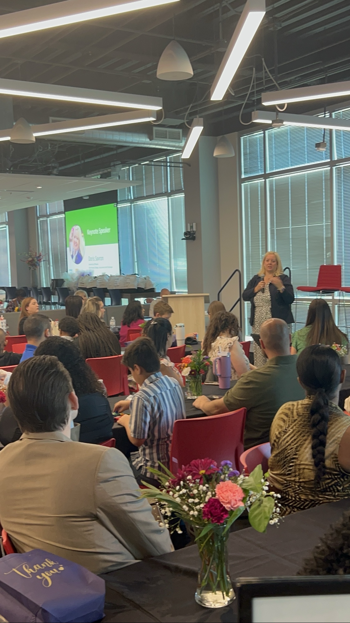 Doris Savron delivering the keynote address at the 2025 Inspired LeadHER graduation.